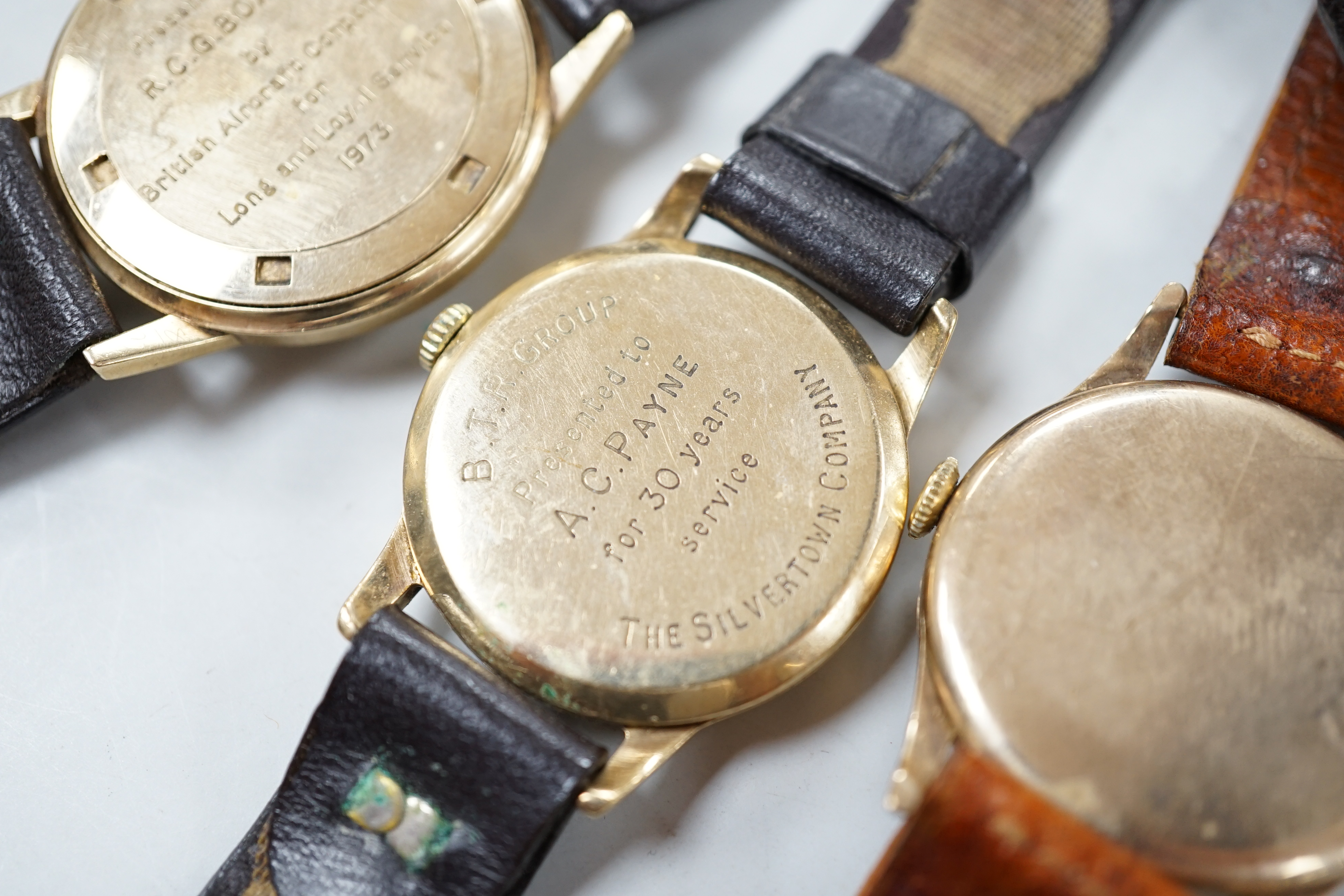 Two gentleman's 9ct gold manual wind wrist watches, retailed by Garrards, both with engraved inscription and two other 9ct gold wrist watches including Eterna.